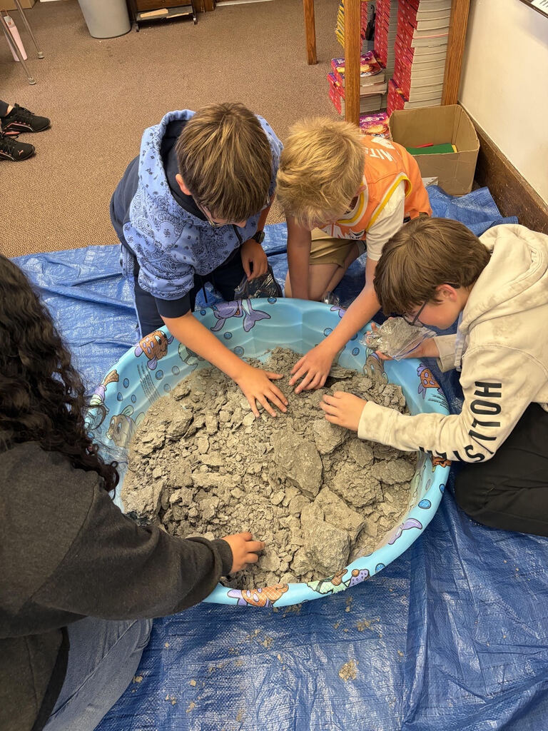 Mrs. Bergman’s science class became paleontologists during a fossil dig using shale from Sylvania, Ohio! Students discovered real fossils including brachiopods, coral, and other ancient marine life hidden inside the rocks. This activity helped students learn about fossils, sedimentary rocks, and how Ohio was once covered by an ancient sea hundreds of millions of years ago. The best part — students were able to keep the fossils they found! 