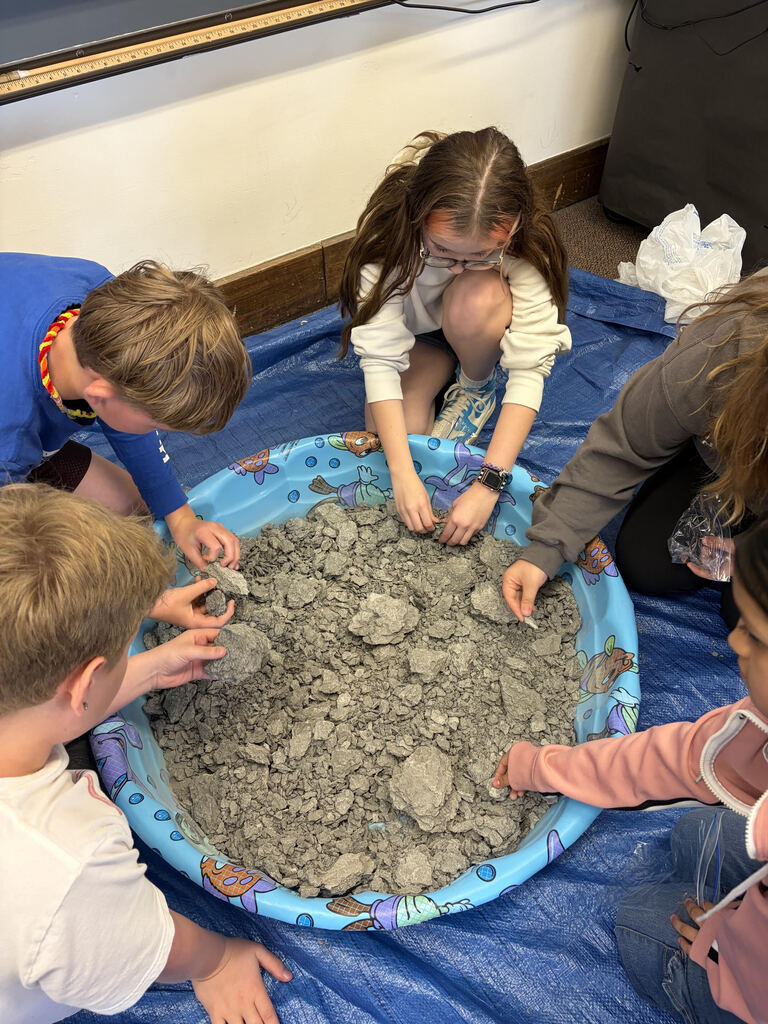 Mrs. Bergman’s science class became paleontologists during a fossil dig using shale from Sylvania, Ohio! Students discovered real fossils including brachiopods, coral, and other ancient marine life hidden inside the rocks. This activity helped students learn about fossils, sedimentary rocks, and how Ohio was once covered by an ancient sea hundreds of millions of years ago. The best part — students were able to keep the fossils they found! 