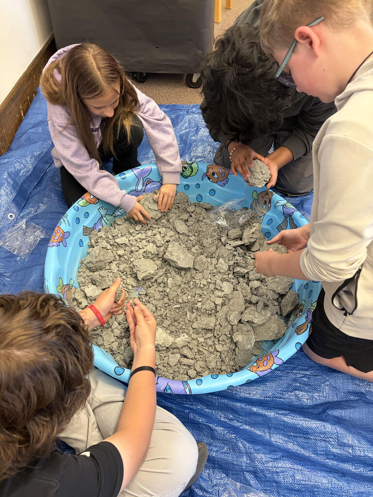 Mrs. Bergman’s science class became paleontologists during a fossil dig using shale from Sylvania, Ohio! Students discovered real fossils including brachiopods, coral, and other ancient marine life hidden inside the rocks. This activity helped students learn about fossils, sedimentary rocks, and how Ohio was once covered by an ancient sea hundreds of millions of years ago. The best part — students were able to keep the fossils they found! 