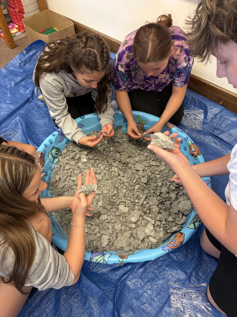Mrs. Bergman’s science class became paleontologists during a fossil dig using shale from Sylvania, Ohio! Students discovered real fossils including brachiopods, coral, and other ancient marine life hidden inside the rocks. This activity helped students learn about fossils, sedimentary rocks, and how Ohio was once covered by an ancient sea hundreds of millions of years ago. The best part — students were able to keep the fossils they found! 