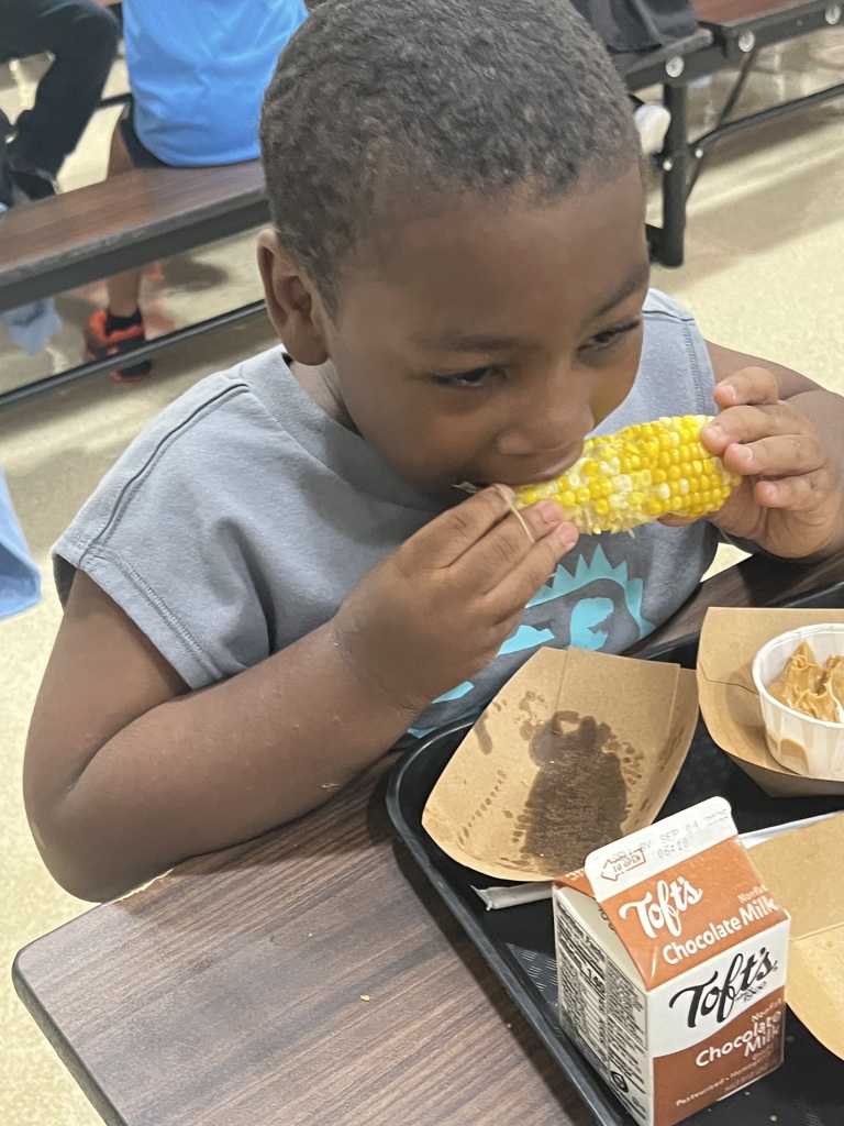 kid eating corn
