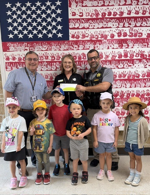 Fran Boucher of VacationLand Federal Credit Union recently presented Principal Ken Moore and School Resource Officer Mike Conney with a generous donation for the upcoming Reading Under the Lights event!The Reading Across America for 250 Years event will take place on Monday, September 21, from 5:45 PM – 7:30 PM at Contractors Stadium.We are so grateful for our community partners who help make events like this possible. Mark your calendars and come join the fun!