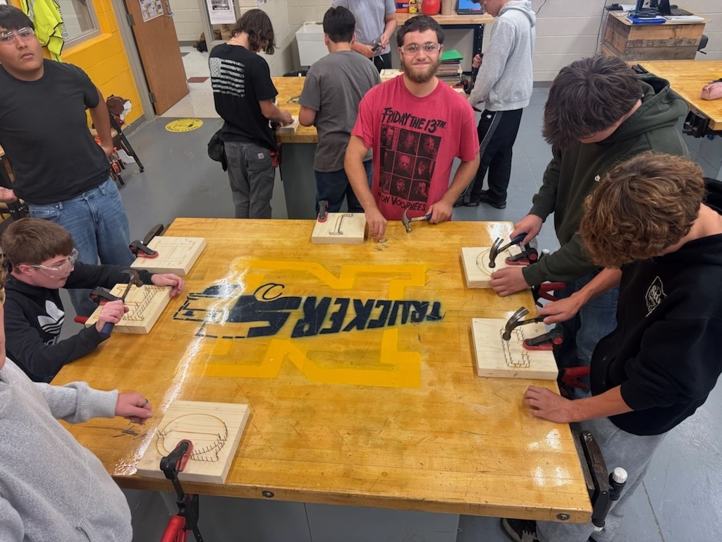 Students in Industrial Education 1 working on their string art projects.