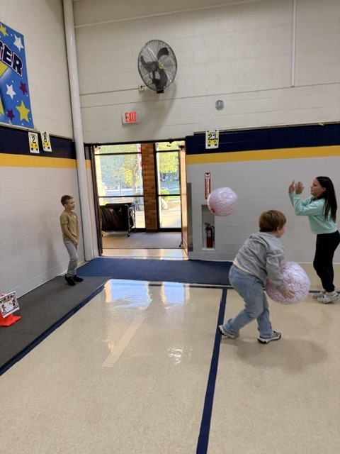 2nd and 3rd grade PE students are having fun reviewing underhand throwing, rolling, and catching with Halloween stations. Mrs. Loomis joined in on the fun and was showing the kids her skills!