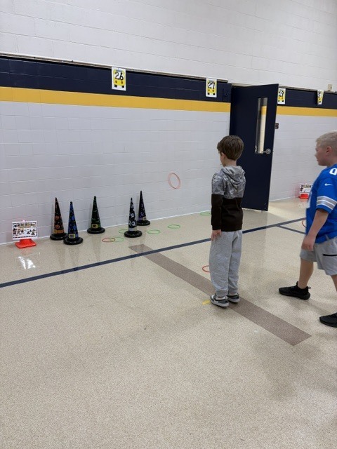 2nd and 3rd grade PE students are having fun reviewing underhand throwing, rolling, and catching with Halloween stations. Mrs. Loomis joined in on the fun and was showing the kids her skills!