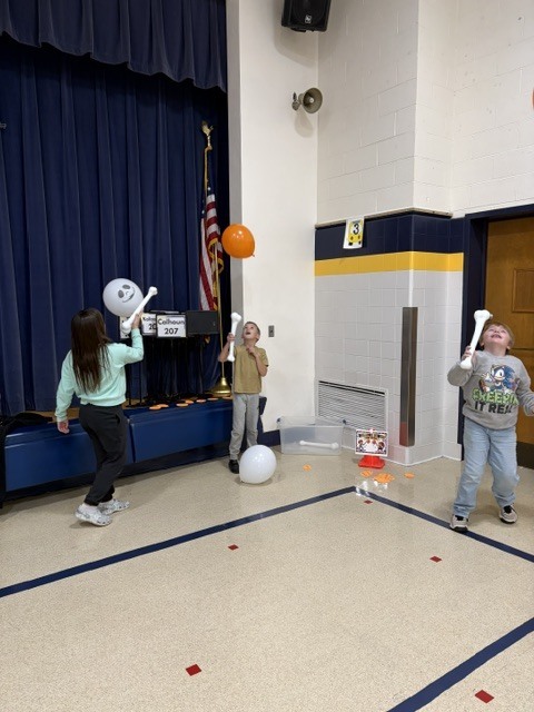 2nd and 3rd grade PE students are having fun reviewing underhand throwing, rolling, and catching with Halloween stations. Mrs. Loomis joined in on the fun and was showing the kids her skills!