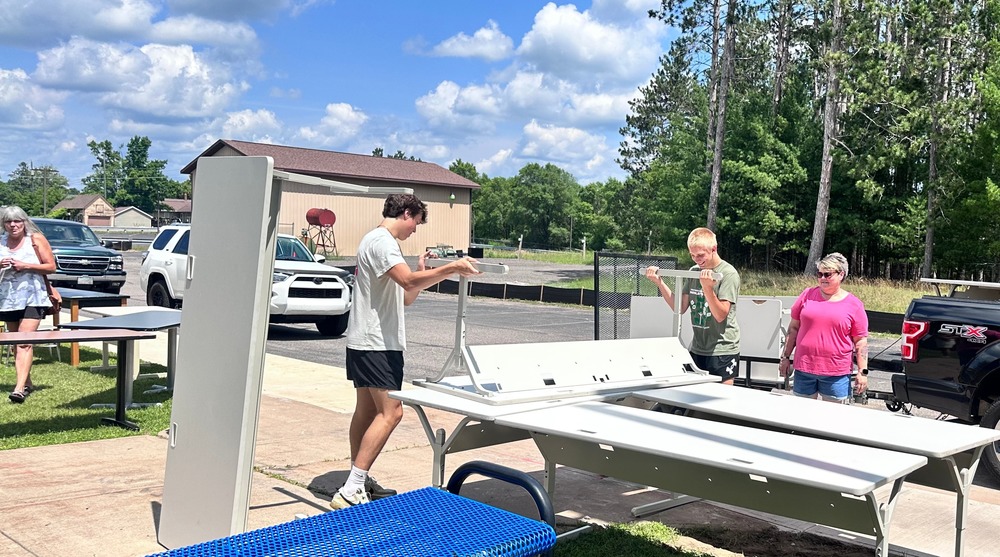 Students Help pass community members pick up furniture