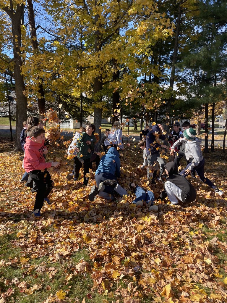 kids at recess throwing leaves at each other
