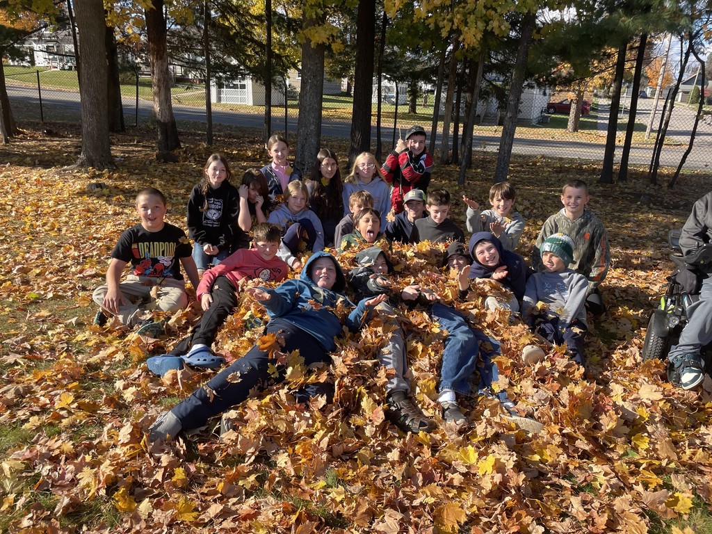 kids at recess throwing leaves at each other