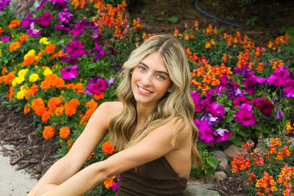 Photo of student of the week, with flowers in the background