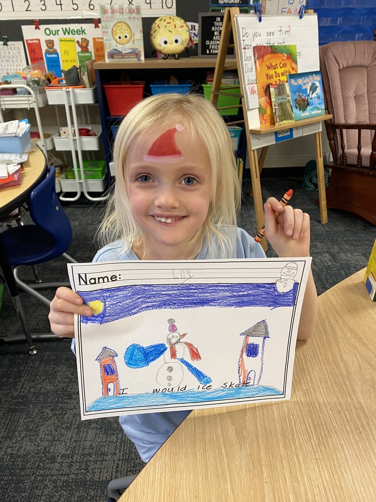 Student with a coloring picture of a snowman ice skating