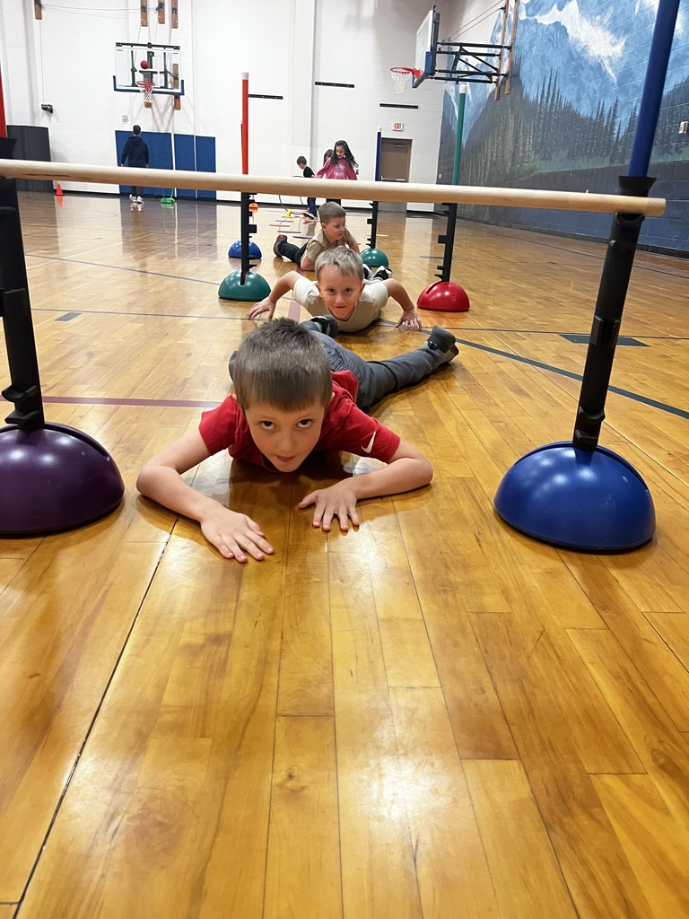 students completing an obstacle course in the gym