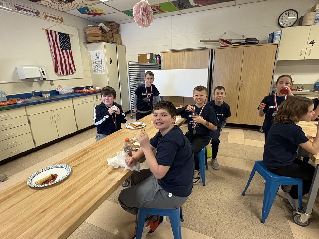 Students celebrating with pizza after reading olympics