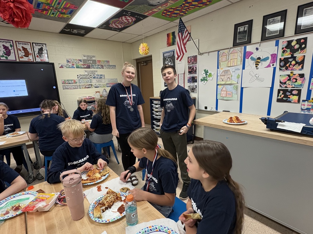Students celebrating with pizza after reading olympics
