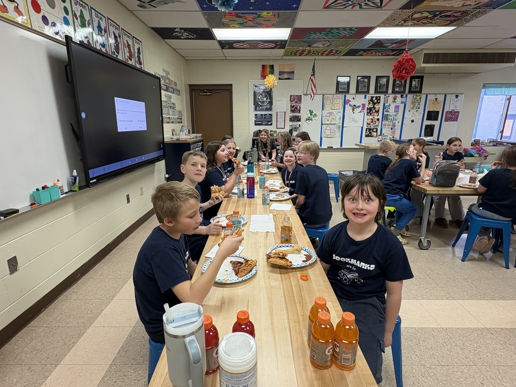 Students celebrating with pizza after reading olympics