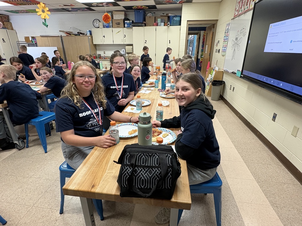 Students celebrating with pizza after reading olympics