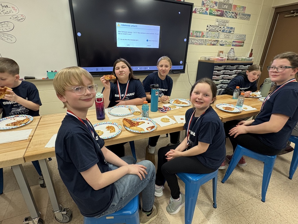 Students celebrating with pizza after reading olympics