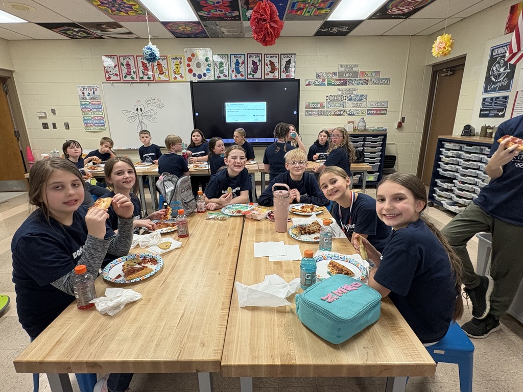 Students celebrating with pizza after reading olympics