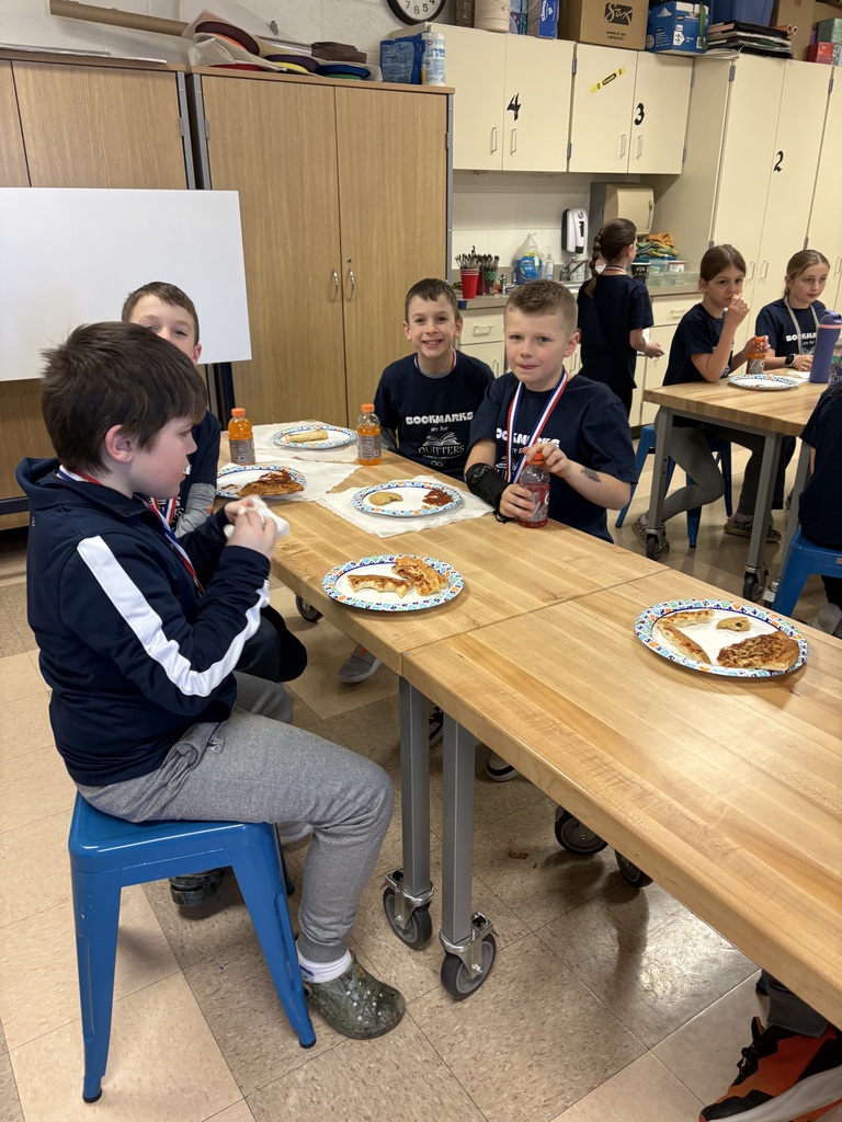 Students celebrating with pizza after reading olympics
