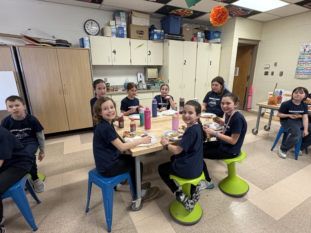 Students celebrating with pizza after reading olympics