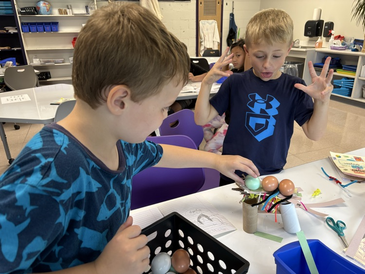 students amazed at being able to hold 3 wooden eggs