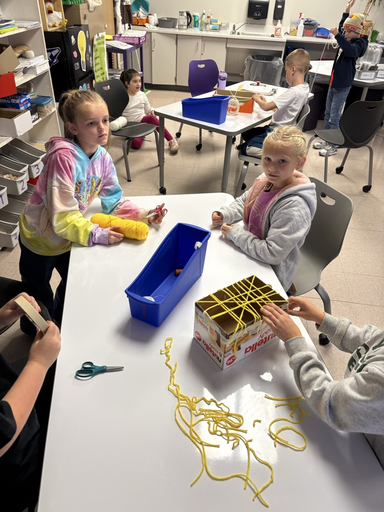 students mid build of their yarn spider web
