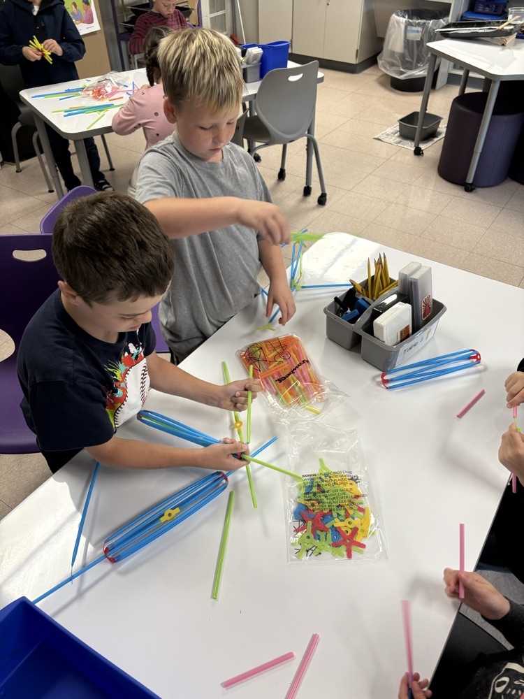 students exploring with Strawbees building materials