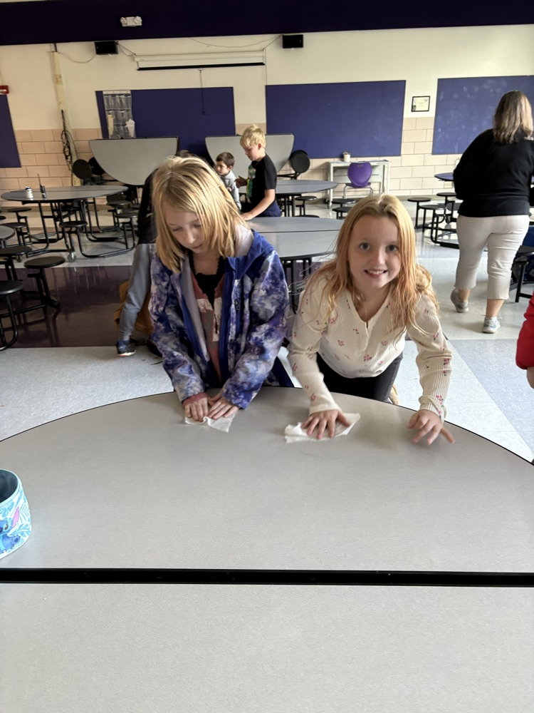 students wiping down tables