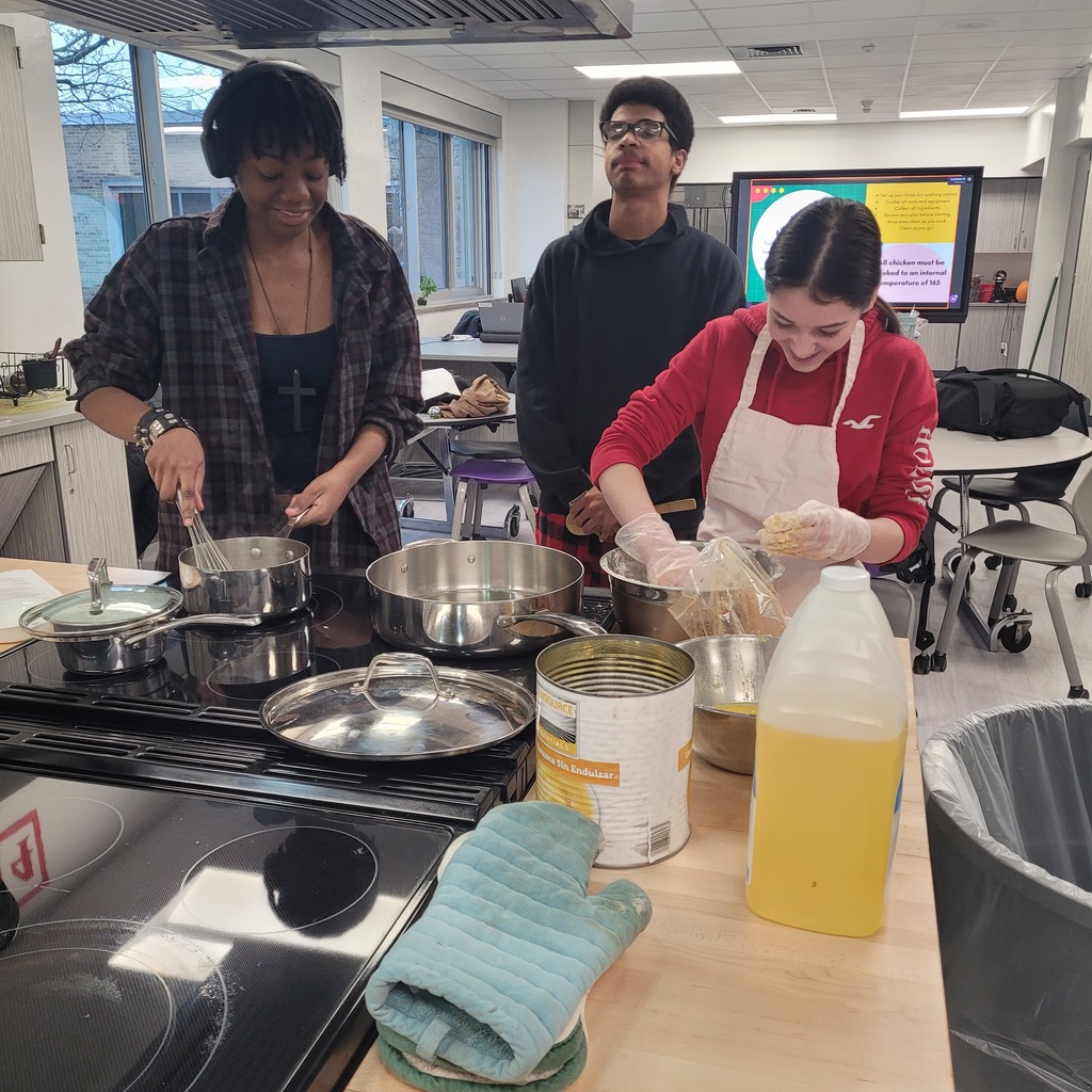 Lillie Hathaway and Alex Moncoeur creating fried chicken and gravy. 