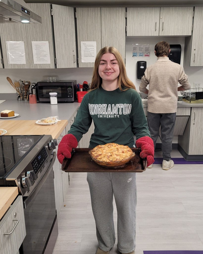 Raegan Doliver taking a beautiful apple pie from the oven.