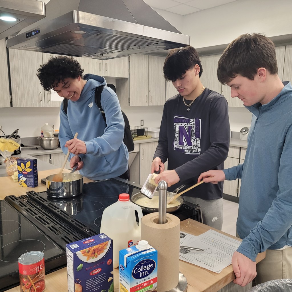 Noah Eddy, Brooks Boland, and Josh Martin making Southern Style Mac and Cheese to go along with pulled pork.