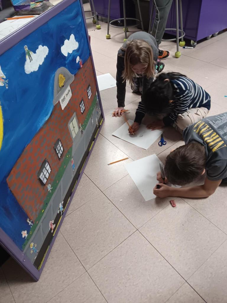 Students working on people for mural