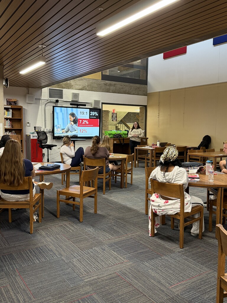 Students in library listening to presentation from UC Admissions Counselor