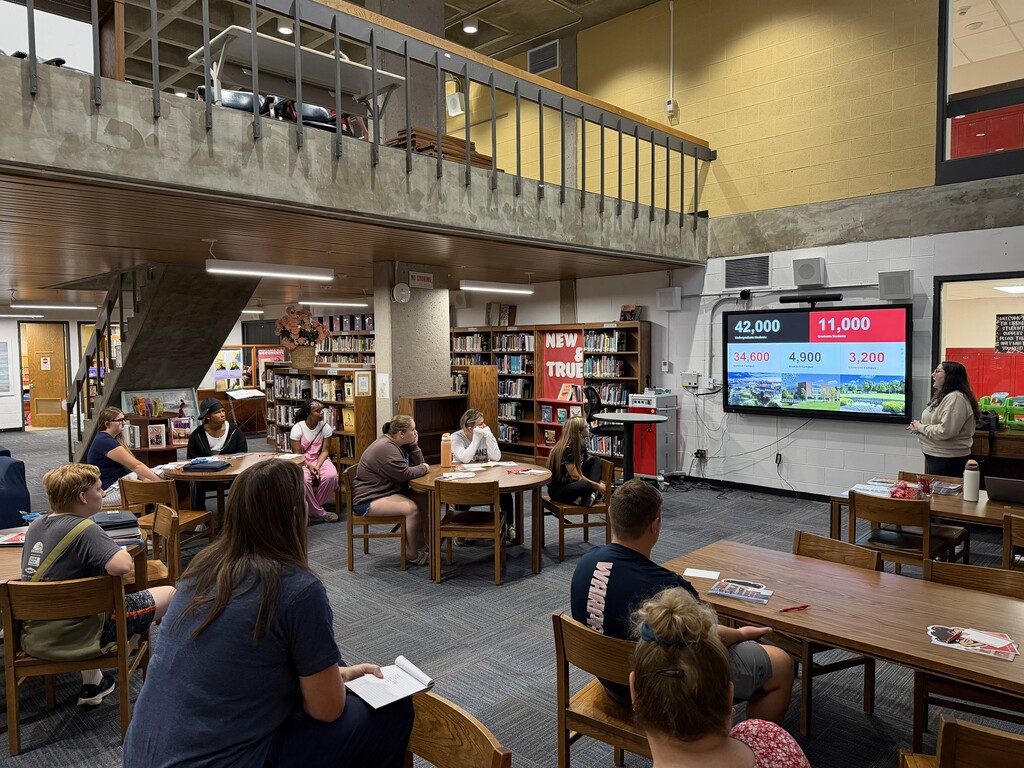 Students in library listening to presentation from UC Admissions Counselor