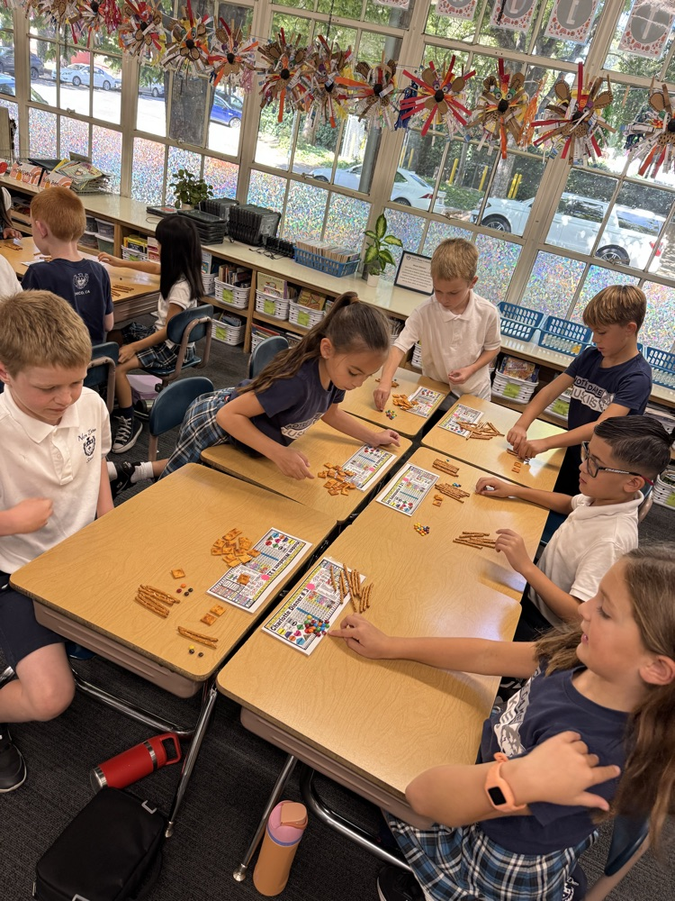 Second grade uses food for Fun Friday to solve double and triple digit addition using 100s, 10s, 1s