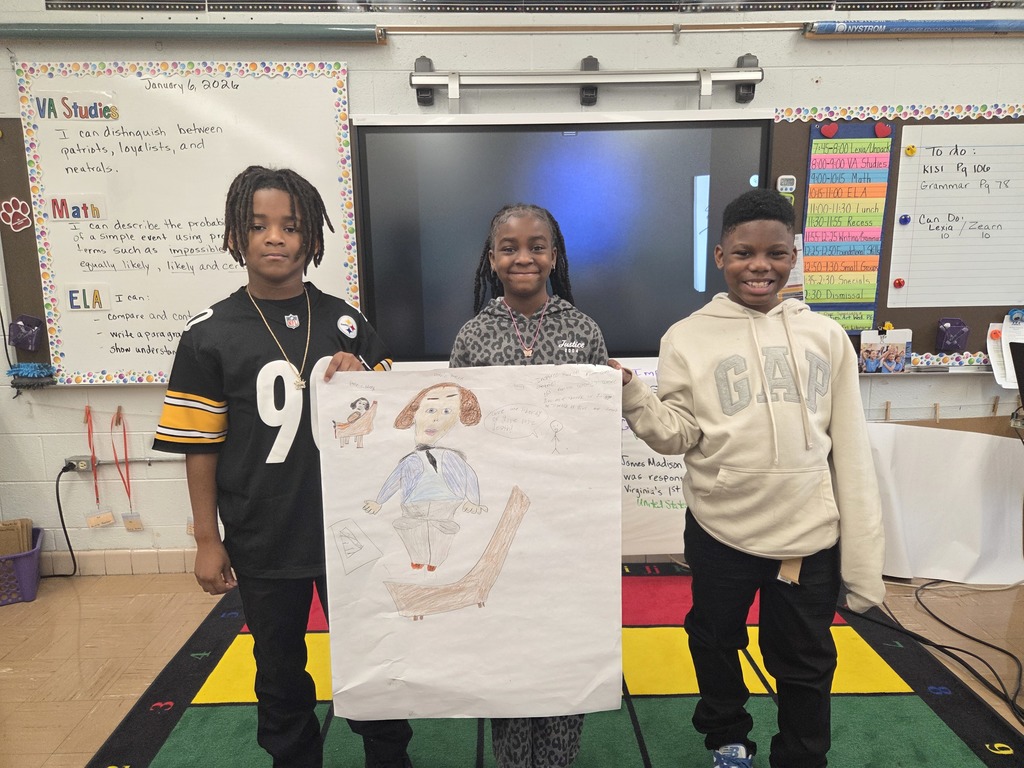 Students holding the posters they created.