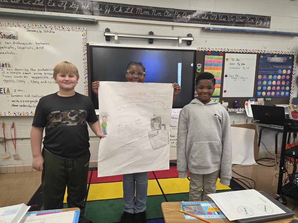 Students holding the posters they created.