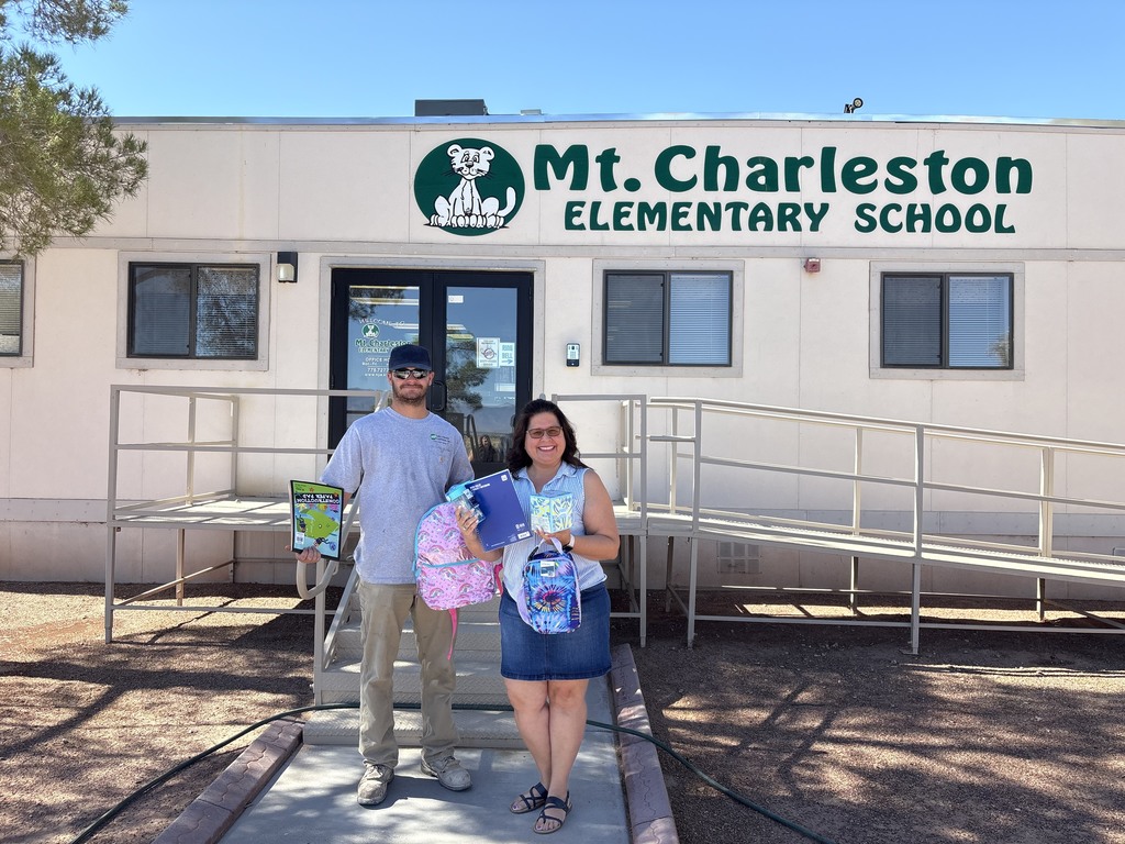 Ms. Gilligan outside our school receive donations from VEA