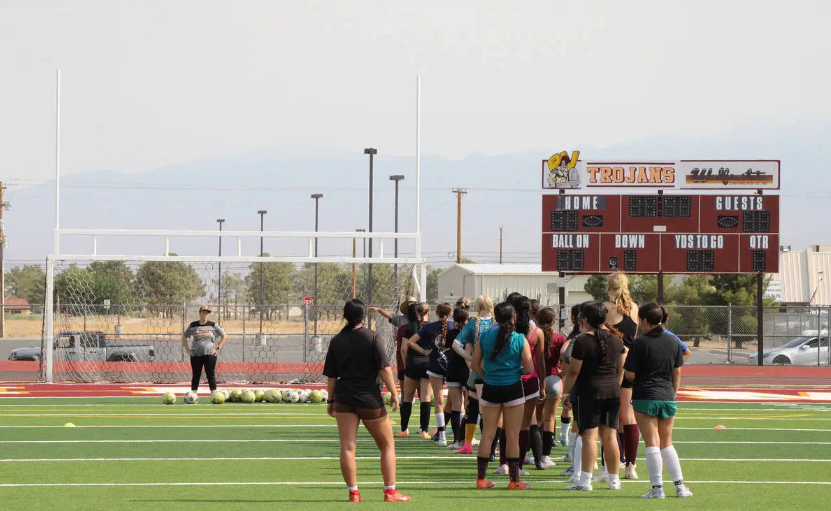 Pahrump Valley High School girls soccer assistant coach Maddie Sandoval (left) directs players during the first day of tryouts for the program at Pahrump Valley High School. (Jacob Powers/Pahrump Valley Times)