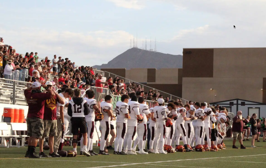 The Pahrump Valley High School stands for the pledge of allegiance before their away season opener against Pinecrest Academy Cadence. (Jacob Powers/Pahrump Valley Times)