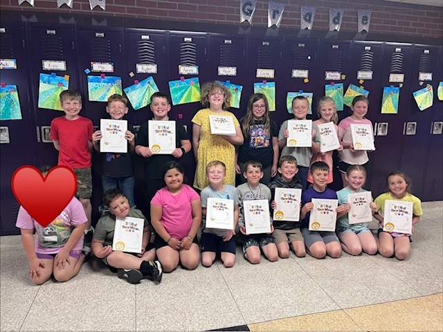 Odebolt 2nd Grade shown with book they published with their own writings and pictures.