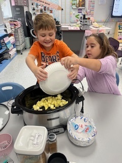 Adding the apples to the crockpot!