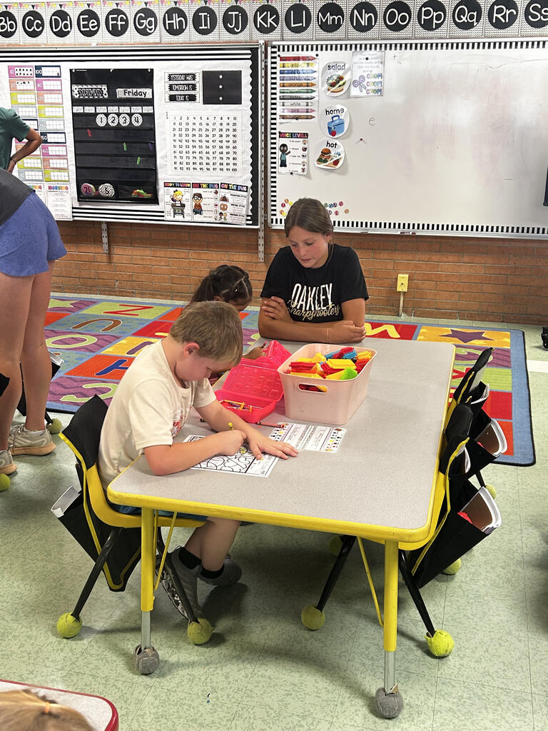 FFA officers teaching kindergarteners about bees and pollinators.