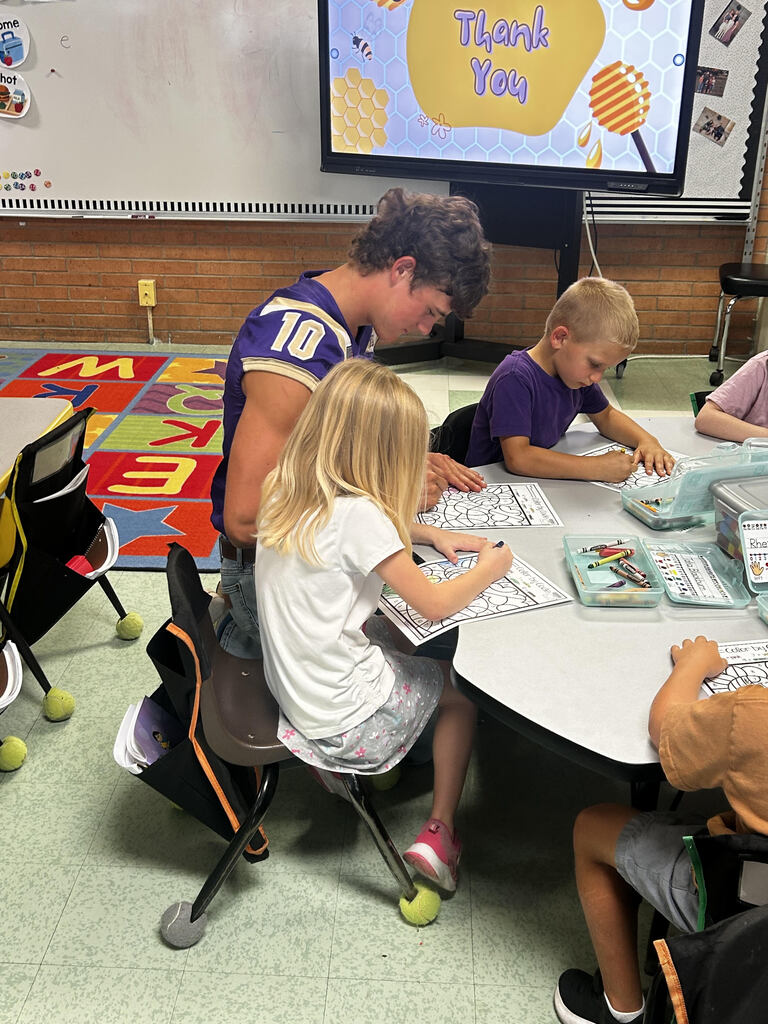 FFA officers teaching kindergarteners about bees and pollinators.