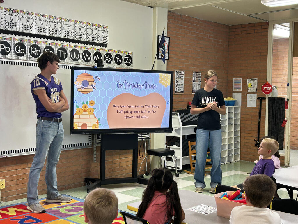 FFA officers teaching kindergarteners about bees and pollinators.