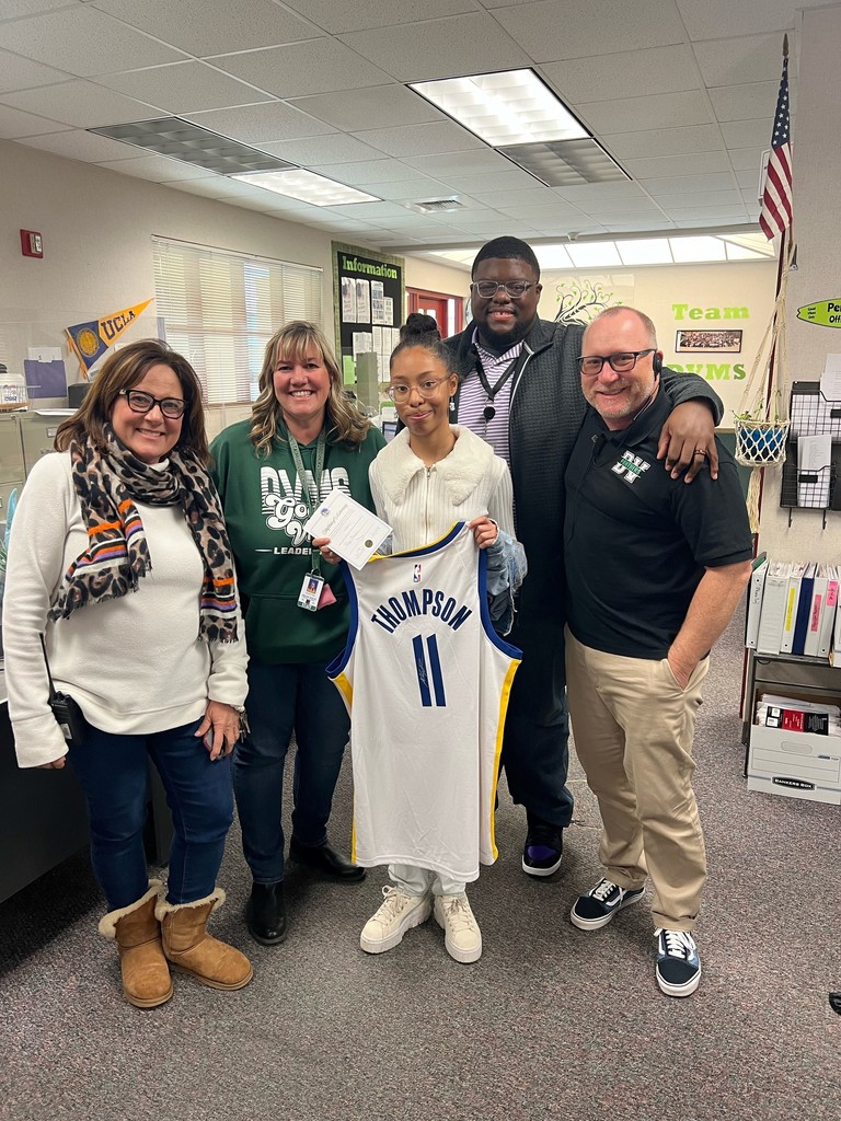 Director of School Nutrition, John McTear, the principal, Rusty Ehrlich, vice principals, Jennifer Hays and Tracey Morse, presenting Kaylee Kendall with a autographed Klay Thompson jersey for winning the National School Breakfast Week Raffle Giveaway.