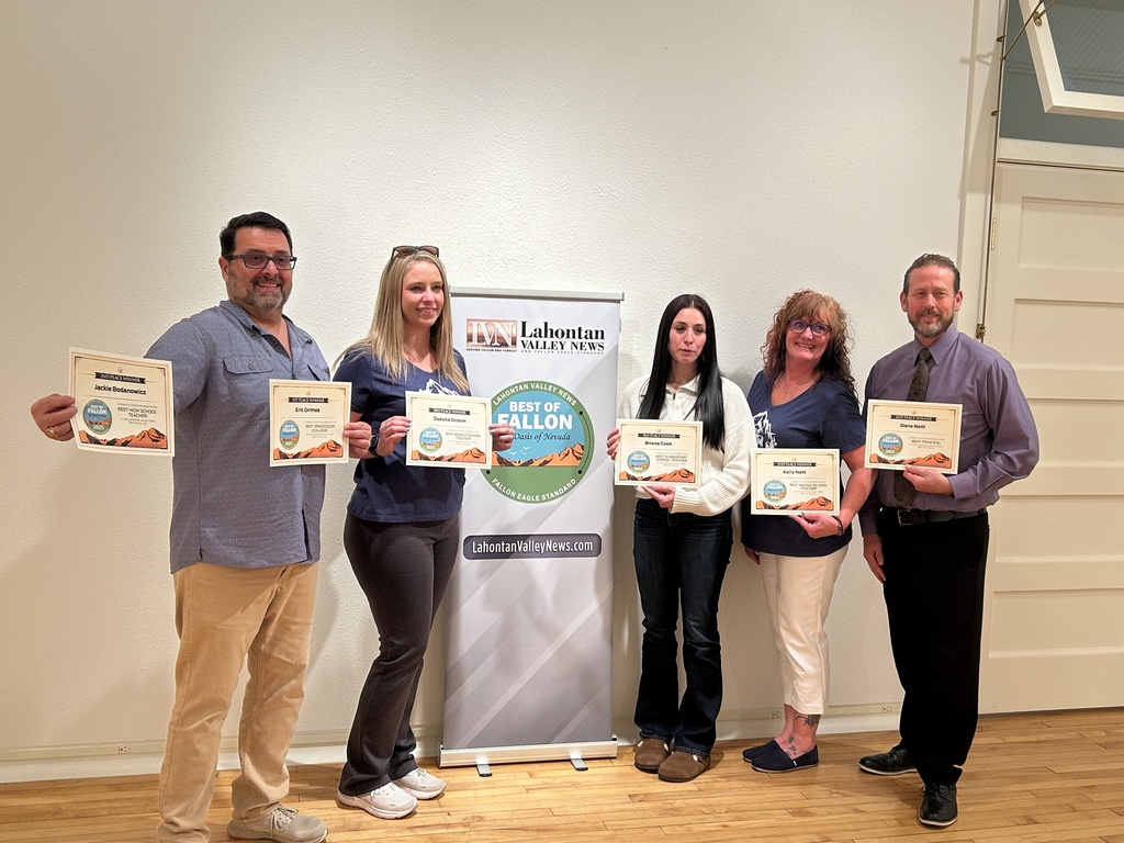 Staff members at Oasis Academy receiving an award. 