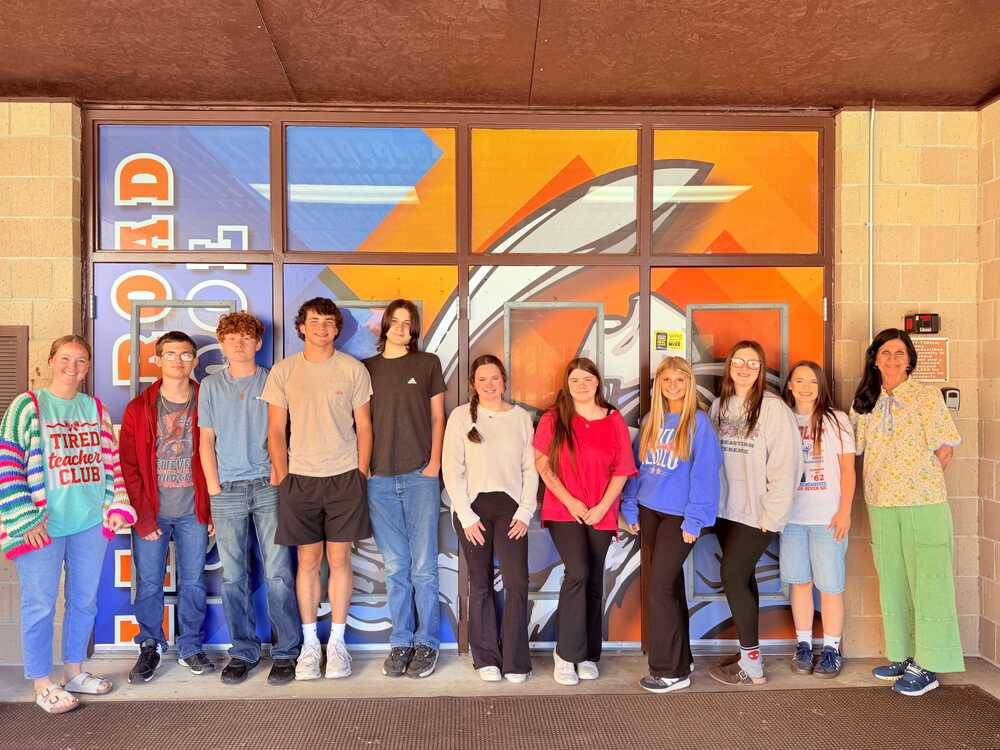 Students and staff from Lake Road Elementary pose for a group photo at the school entrance after the school was awarded a TVA School Uplift Learning Environment Grant.