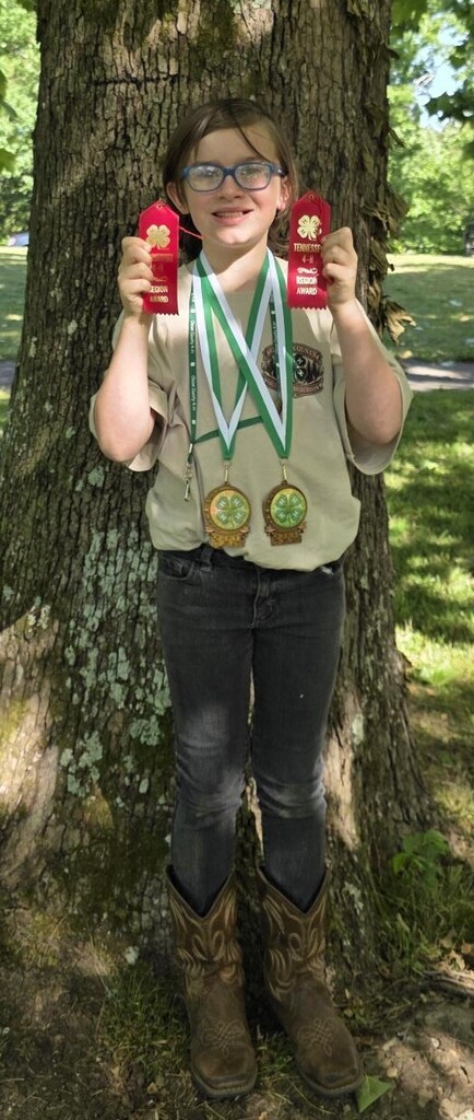 Picture of Nate Lawrence holding his awards.