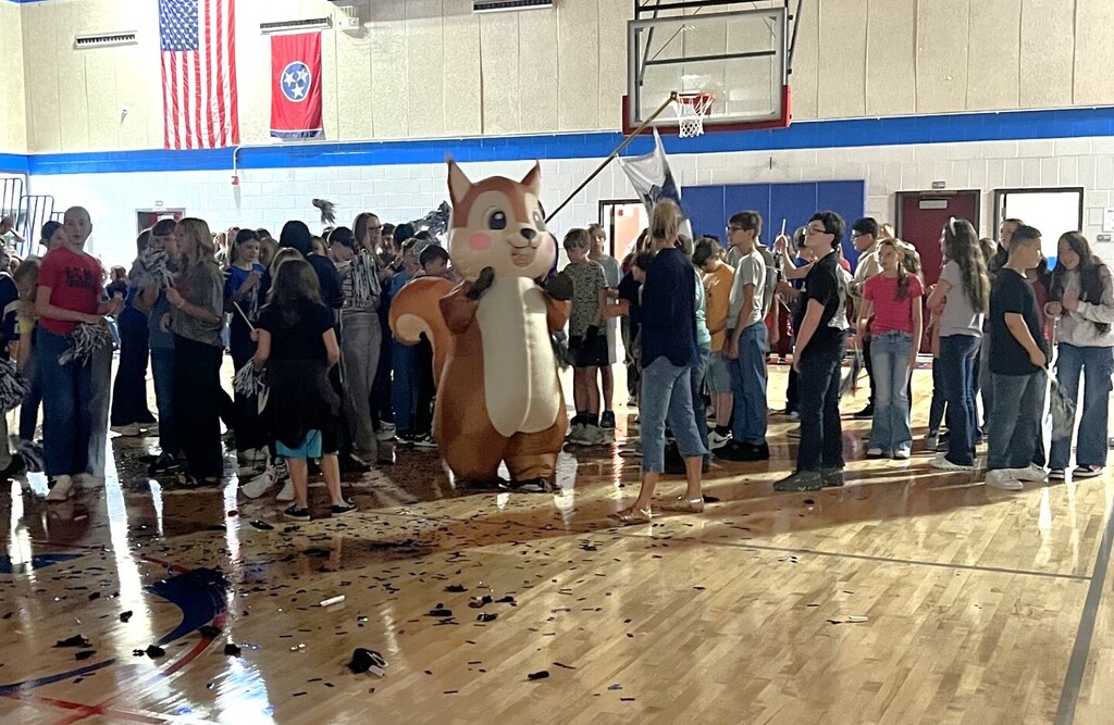 Photo of students and staff participating in house reveal pep rally.